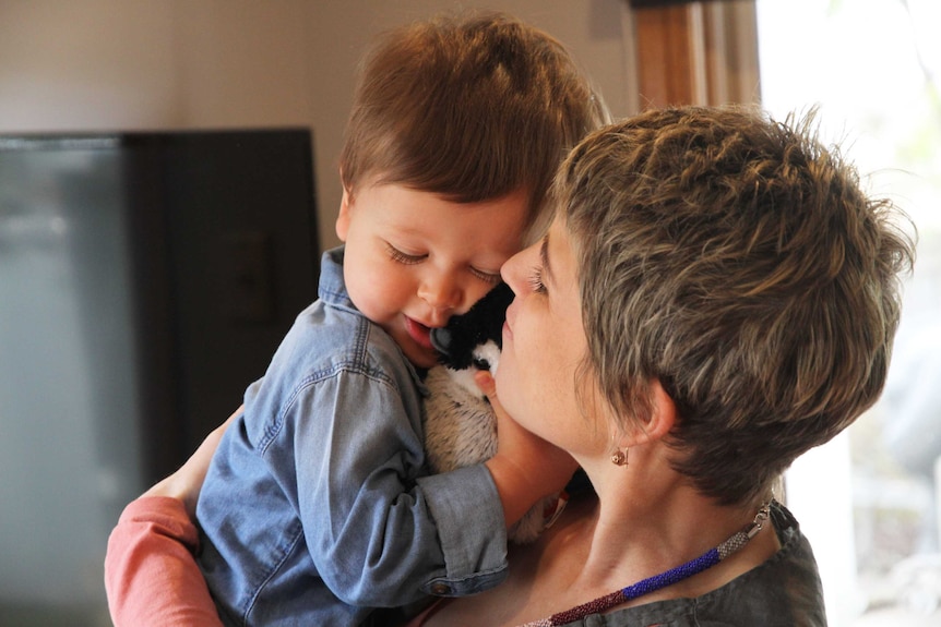 Hugh snuggles up close to mum Julia, who is storing his umbilical cord in case the toddler needs the stem calls in the future