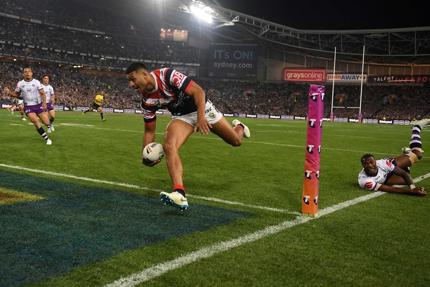 Daniel Tupou prepares to put the ball down as he scores the opening try for the Roosters in the NRL grand final.