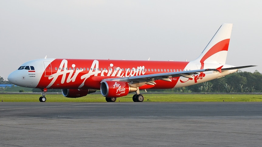 An AirAsia Indonesia Airbus A320 on the tarmac at an unknown airport.