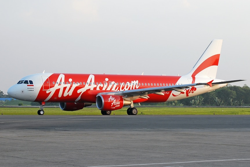 An AirAsia Indonesia Airbus A320 on the tarmac at an unknown airport.