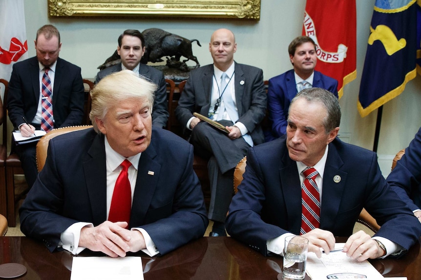 Chris Collins of western New York state, right, sits next to President Donald Trump during a meeting