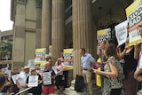About 100 people turned up to protest at Brisbane's historic Customs House