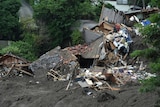 Image of crushed houses and debris surrounded in mud in Atami, Japan