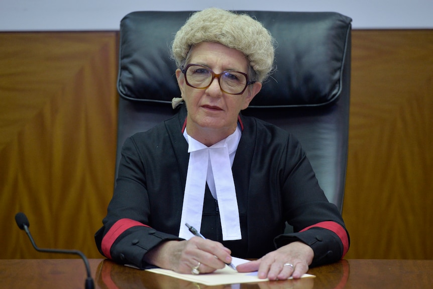 a female judge in robes and a wig