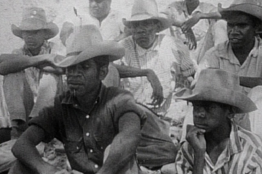 Black and white image of stockmen walking off in protest