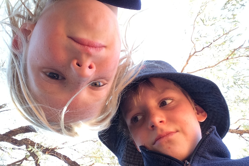 Two children look down on the camera