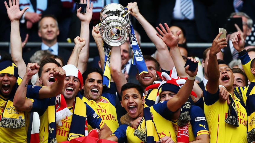 Arsenal celebrates with FA Cup trophy