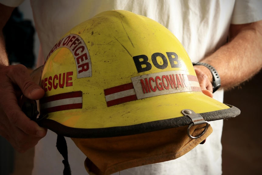Person holds a firefighter helmet