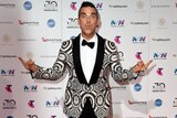 Singer Robbie Williams poses in front of the camera at the Star casino in Sydney for the ARIA Awards.