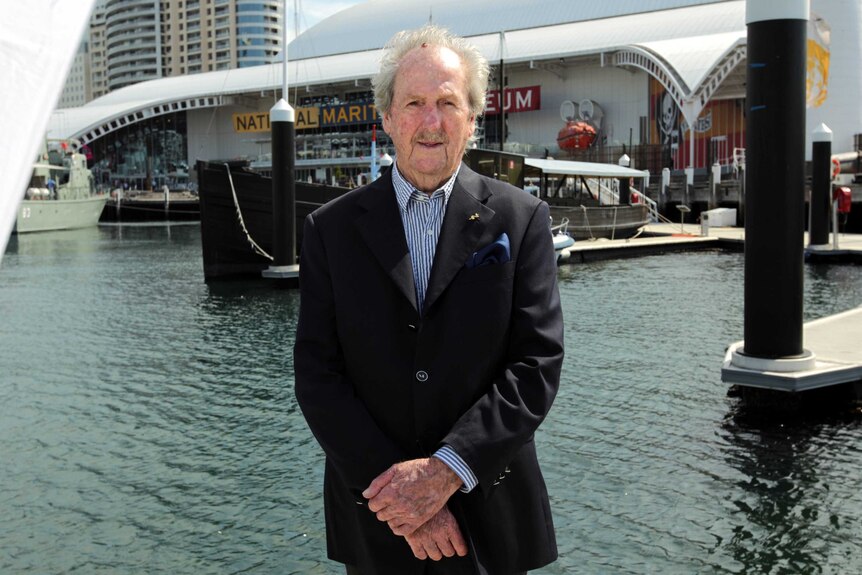 Douglas Herps stands in front of MV Krait in Darling Harbour