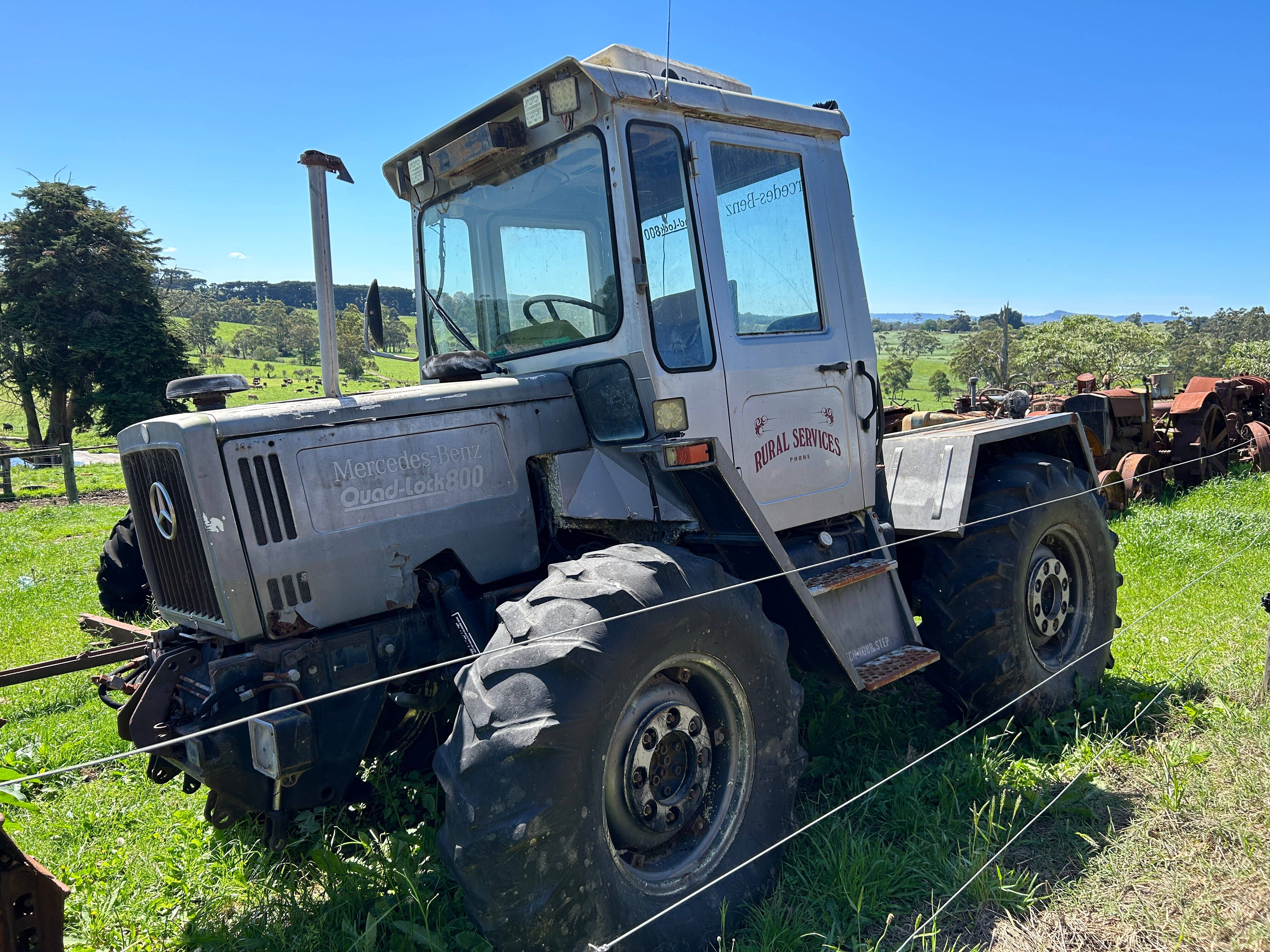 A vintage Mercedes-Benz tractor in a paddock.