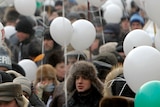 Protesters gather with balloons and placards during a demonstration for fair elections in central Moscow