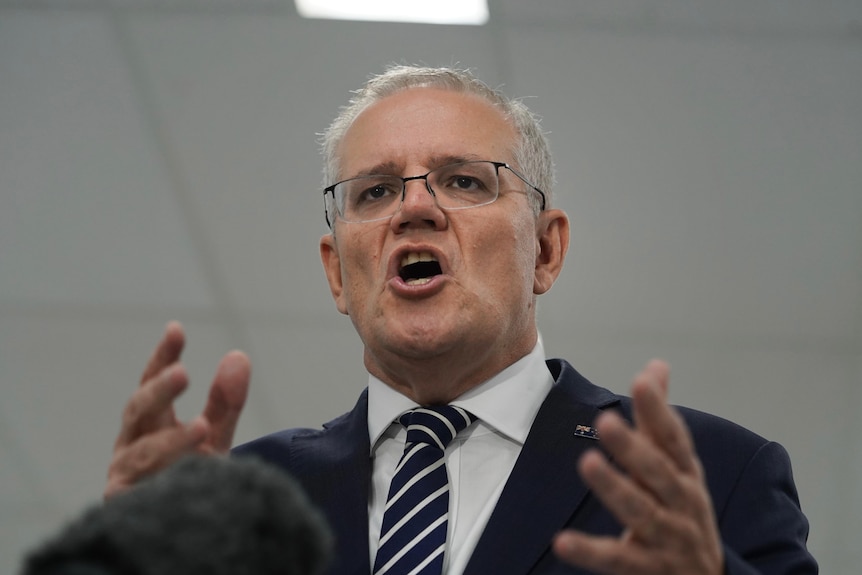Scott Morrison speaks while gesticulating with his hands.