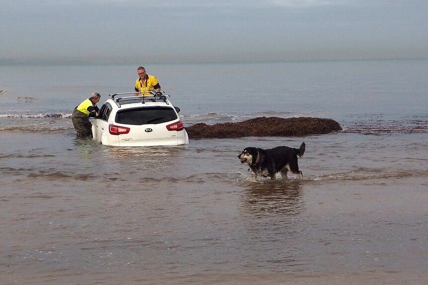 Car in the water at Henley Beach