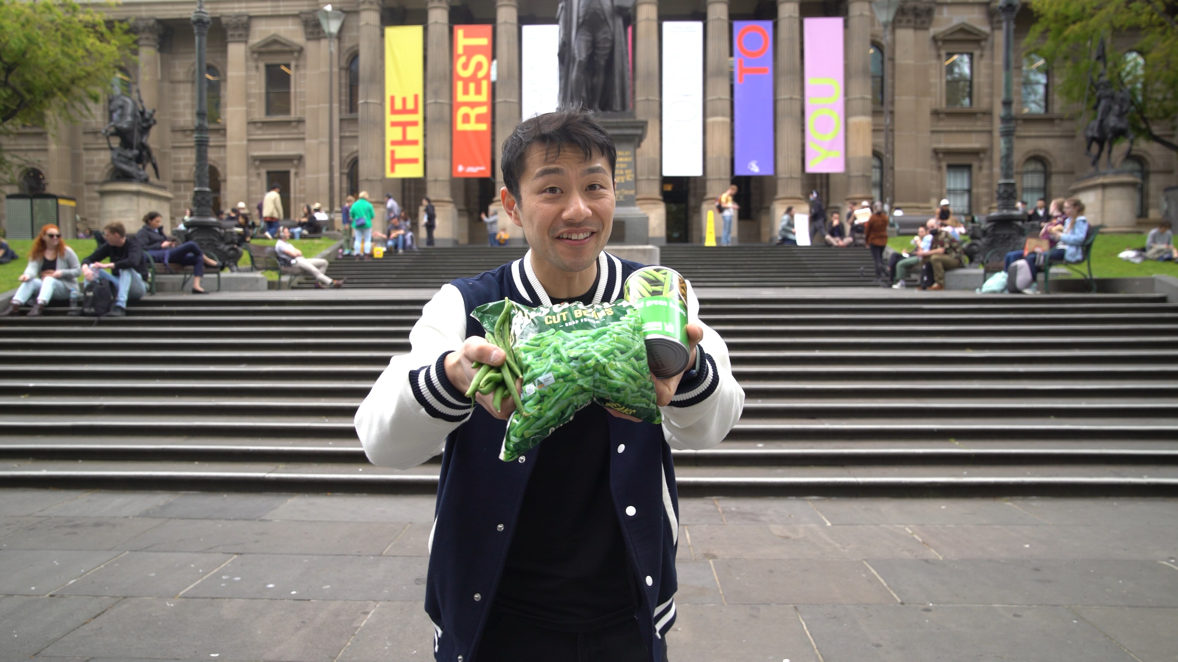 Thanh Truong aka the fruit nerd, holding frozen and canned goods.