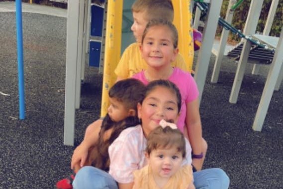 Ms Raad's five kids on a slide, including her youngest nine-month-old daughter (bottom).