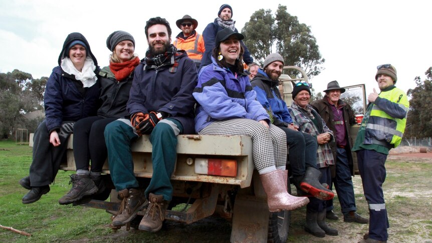 The Perth-based Activate tree-planting crew sit on the back of a ute on a Kojonup farm