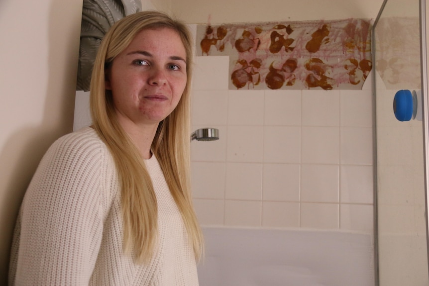 A woman with blonde hair smiles for the camera 