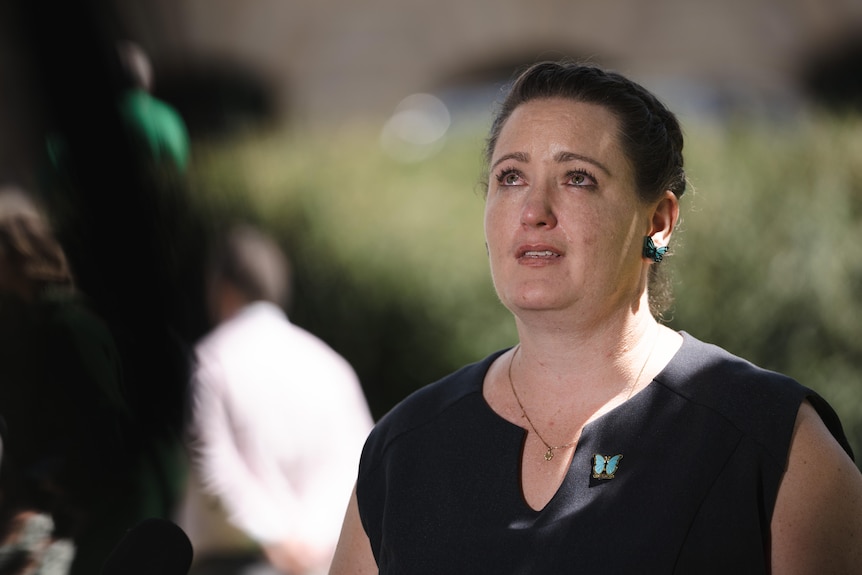 A woman crying, looking up.