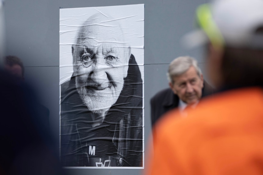Portrait of an old man on a hoarding.