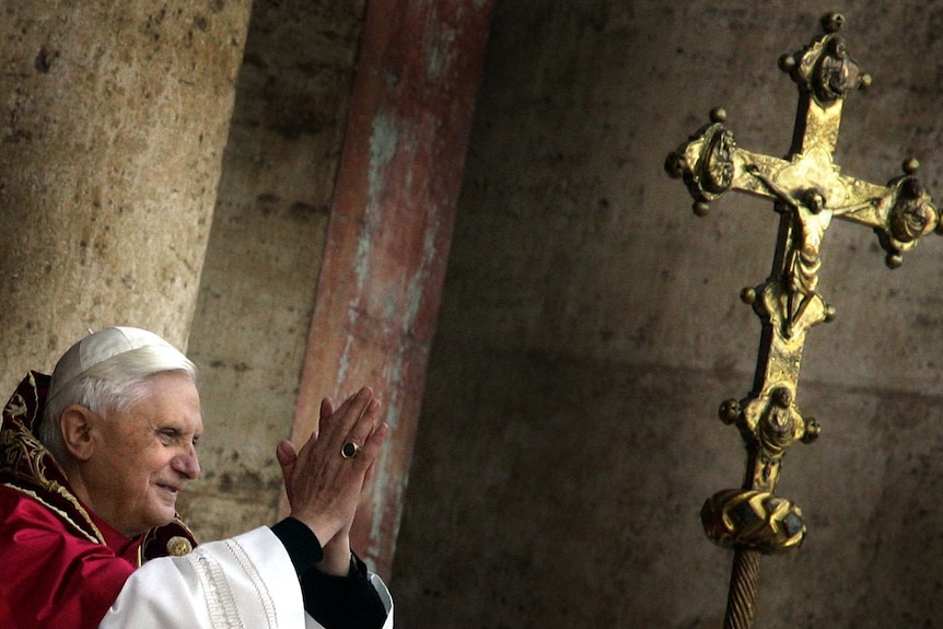 Pope Benedict XVI blesses thousands of pilgrims from the balcony of St Peter's Basilica at the Vatican.