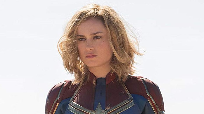Captain Marvel stands in her uniform