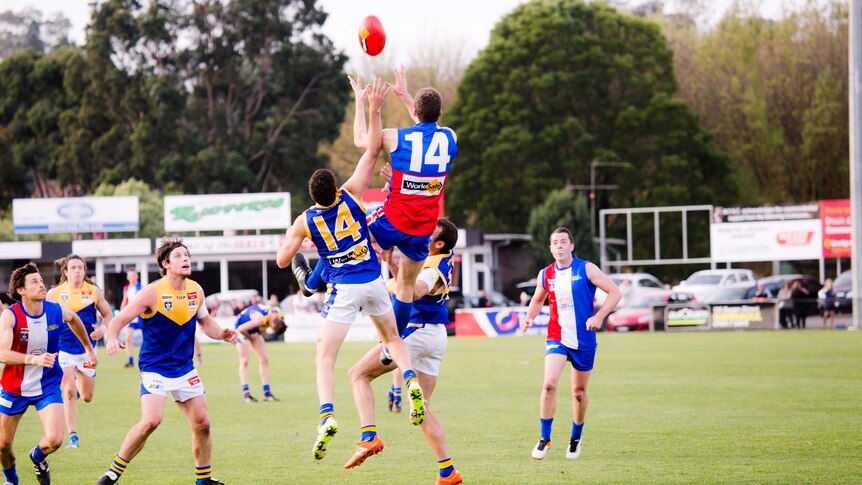 Ben Amberg jumps in the air to take a mark during a game.