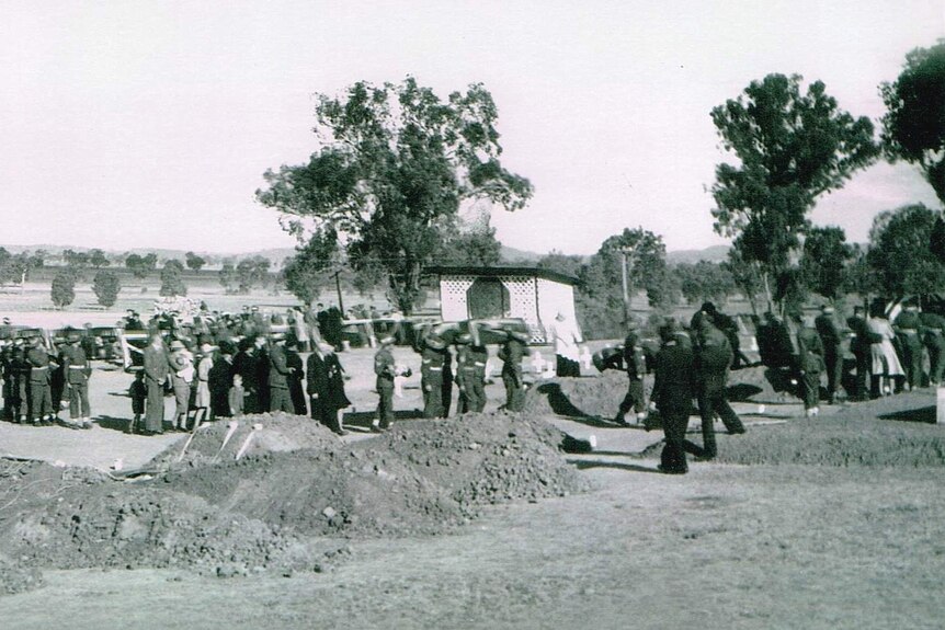 A black and white photograph of the crowd waiting for the military funeral of 26 men killed in an explosion at Kapooka Army Base