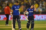 James Anderson (L) and James Taylor walk off after England's Cricket World Cup loss to Australia.