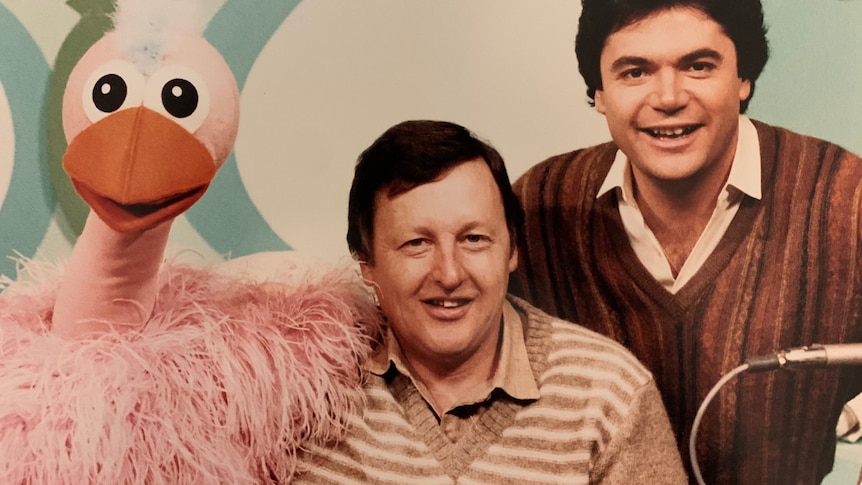 A pink ostrich puppet with Ernie and Daryl.
