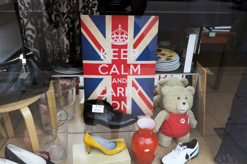 Keep calm and carry on poster in shop window in the UK in July 2020.