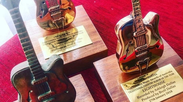 Three Golden Guitar statues, dating back to 1975