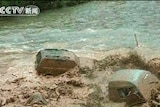 The landslides swept mud, houses, cars and other debris into a river running through Gannan prefecture.