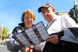 Tourists read a brochure in Hobart