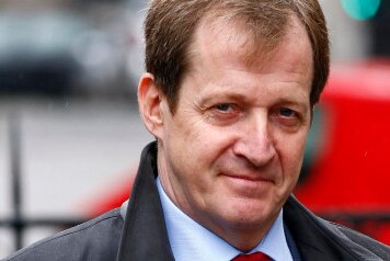 Alastair Campbell wears a shirt and tie and jacket