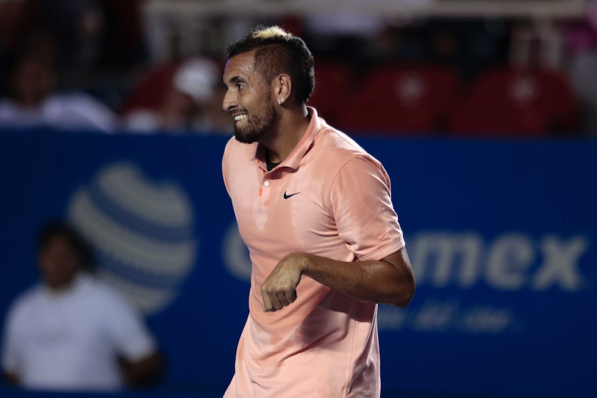 A male tennis player grimaces because of a wrist injury during a tennis match in Acapulco.