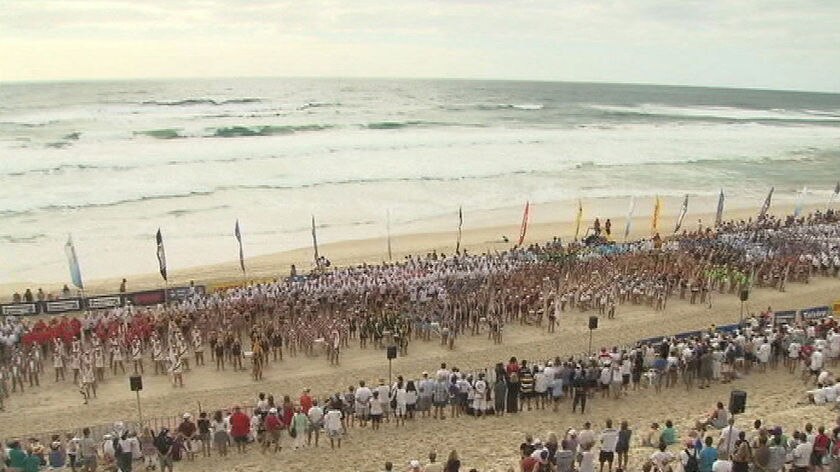 Thousands gather at a service on Kurrawa beach to honour Saxon Bird.