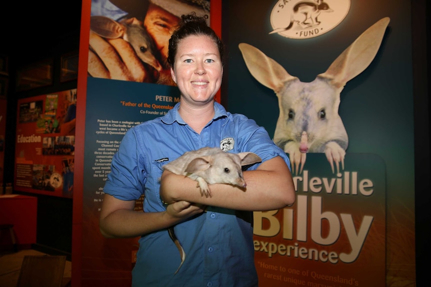 A woman holding a bilby