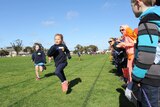 Young school of the air students compete in a 100 meter heat.