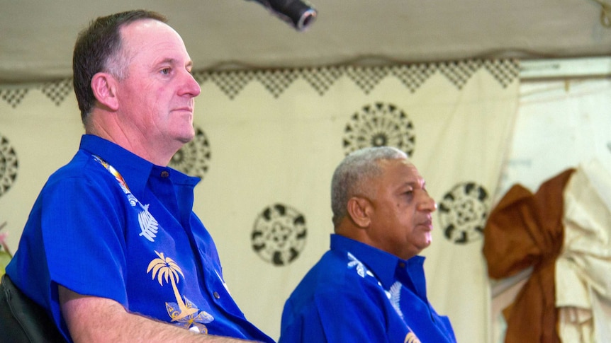 New Zealand's Prime Minister John Key attends a welcome ceremony with his Fiji counterpart Frank Bainimarama in Suva