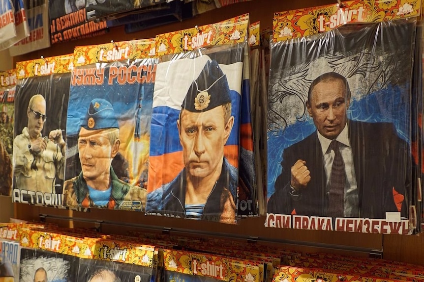 A row of T-shirts mostly showing Russian president Vladimir Putin.