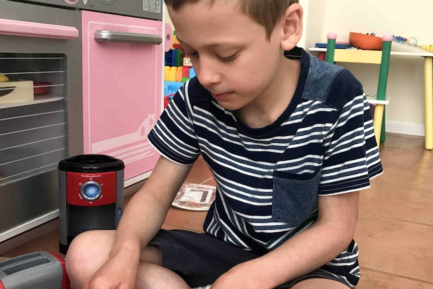 A boy playing with toys.