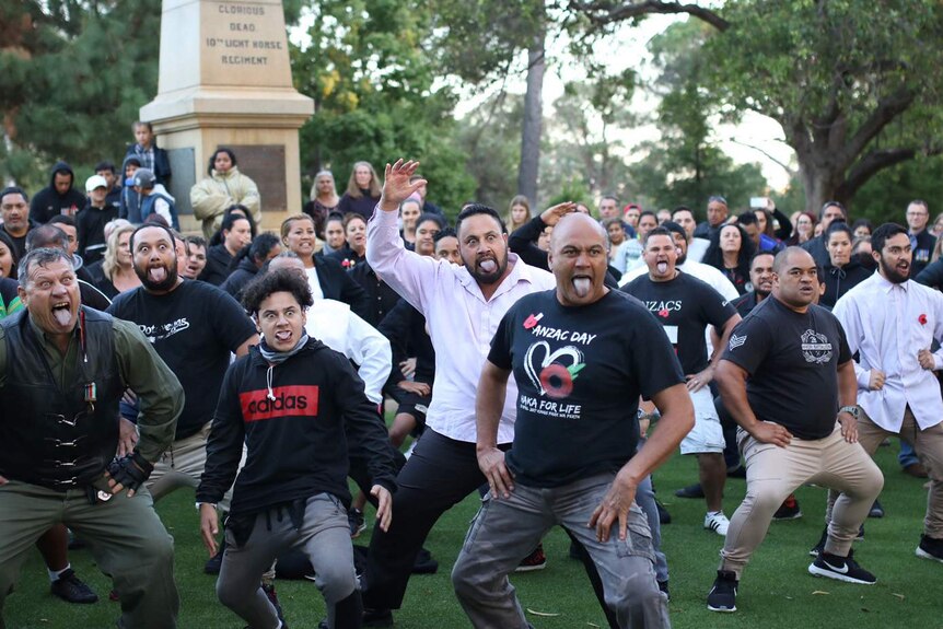 A large group of people performing the haka at Kings Park in Perth.
