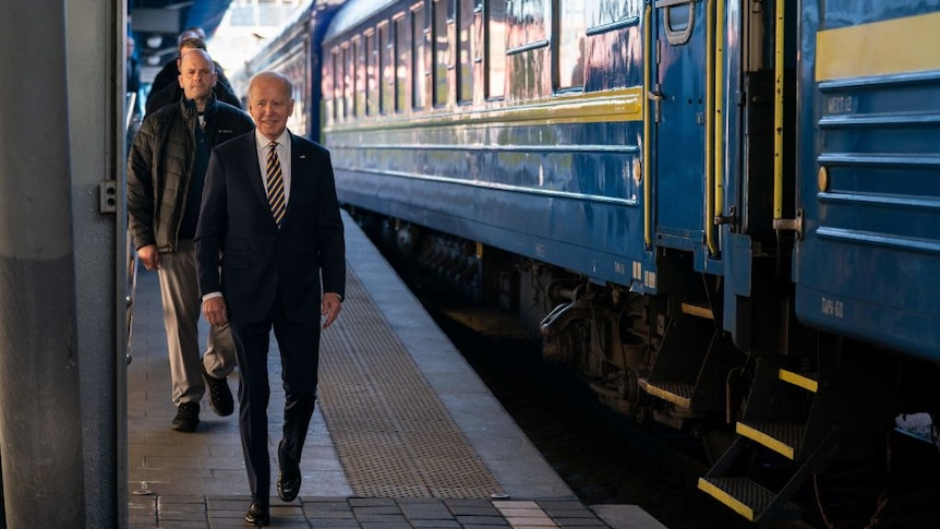 President Biden walks along a railway platform in Kyiv 