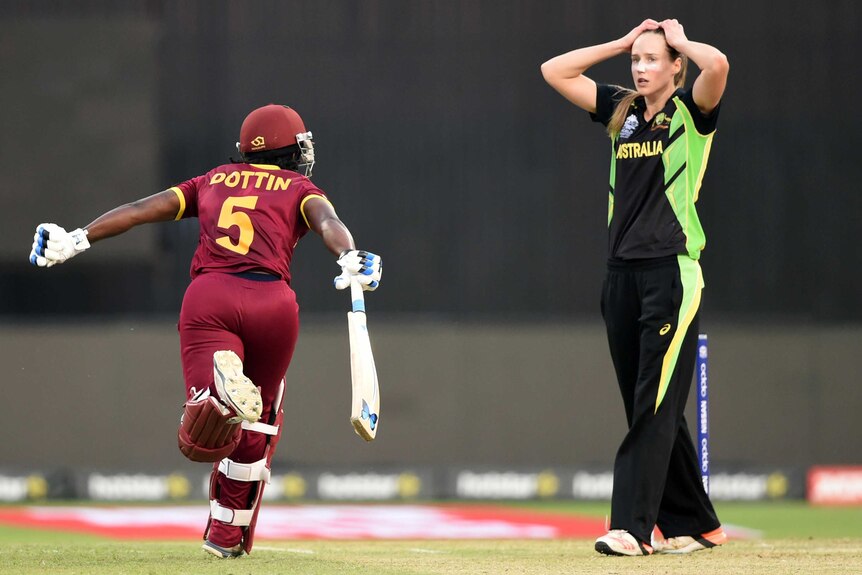 Deandra Dottin celebrates West Indies Women's World Twenty20 win as Ellyse Perry looks on
