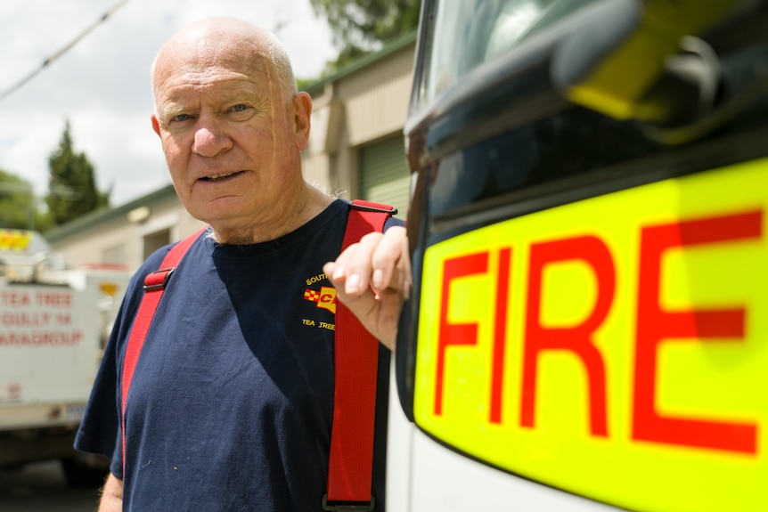 A man in CFS uniform next to a fire truck.