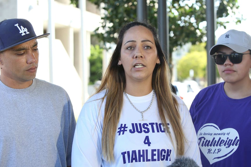 Cindy Palmer, wearing a Justice 4 Tiahleigh t-shirt, speaks to the media