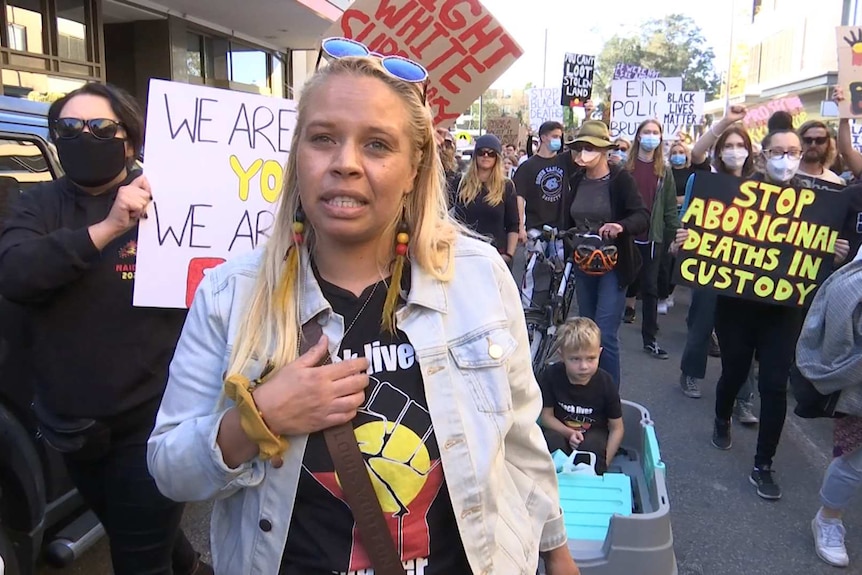 A woman in a crowd of rally participants.