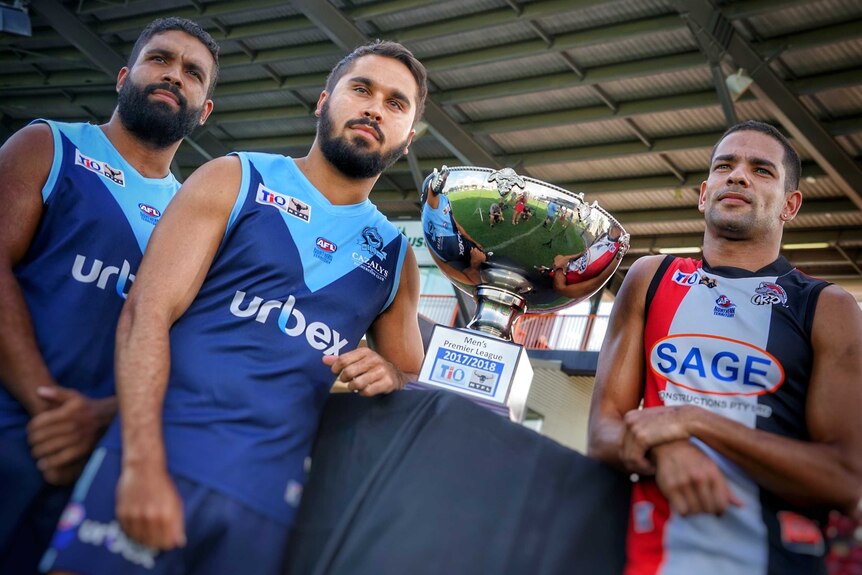 The three captains stand with the trophy at Marrara Stadium.