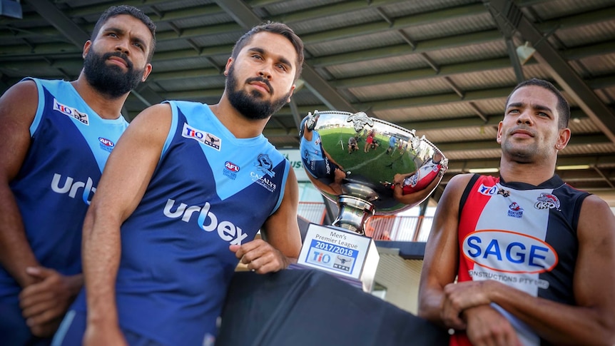 The three captains stand with the trophy at Marrara Stadium.